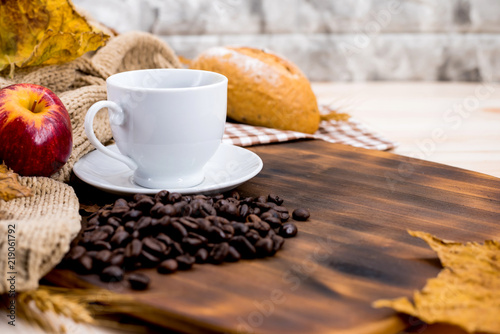 Cup of hot Coffee with toast for Autumn season warm drink. Fall harvest cornucopia. Copy space on wood background. photo