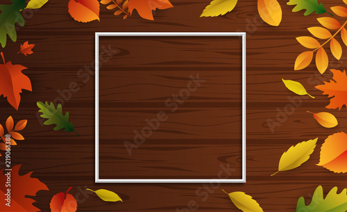 Wooden textured autumn background with beautiful fallen leaves.