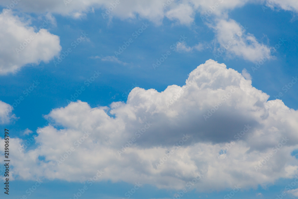 Sunny day with white fluffy clouds