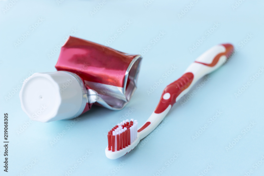 Empty tube of toothpaste and Toothbrush on blue background Empty tube of toothpaste and Toothbrush on blue background