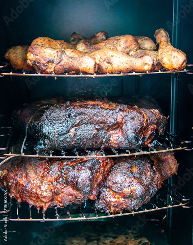 smoking delicious meat and chicken in the smokehouse food concept photo