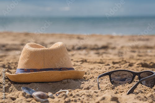 Sunglasses on sandy beach in a summer.