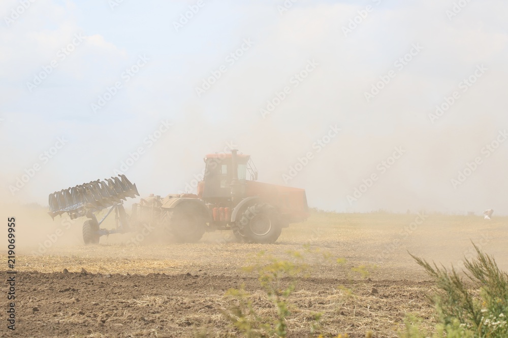 Fototapeta premium The tractor is working in the field. 