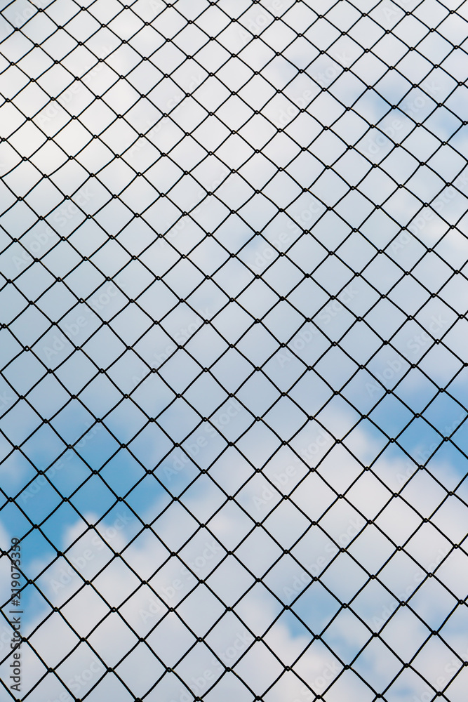 Silhouette of the steel fence barbed wire with blue sky Silhouette of the steel fence barbed wire with blue sky
