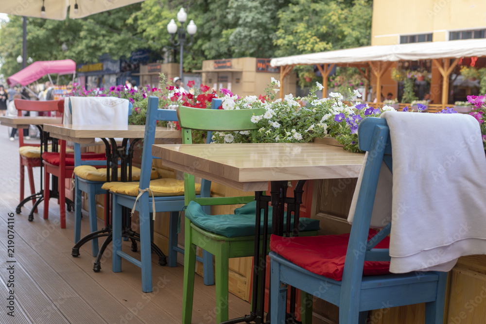 Bright and colorful table and chairs in the summer cafe.