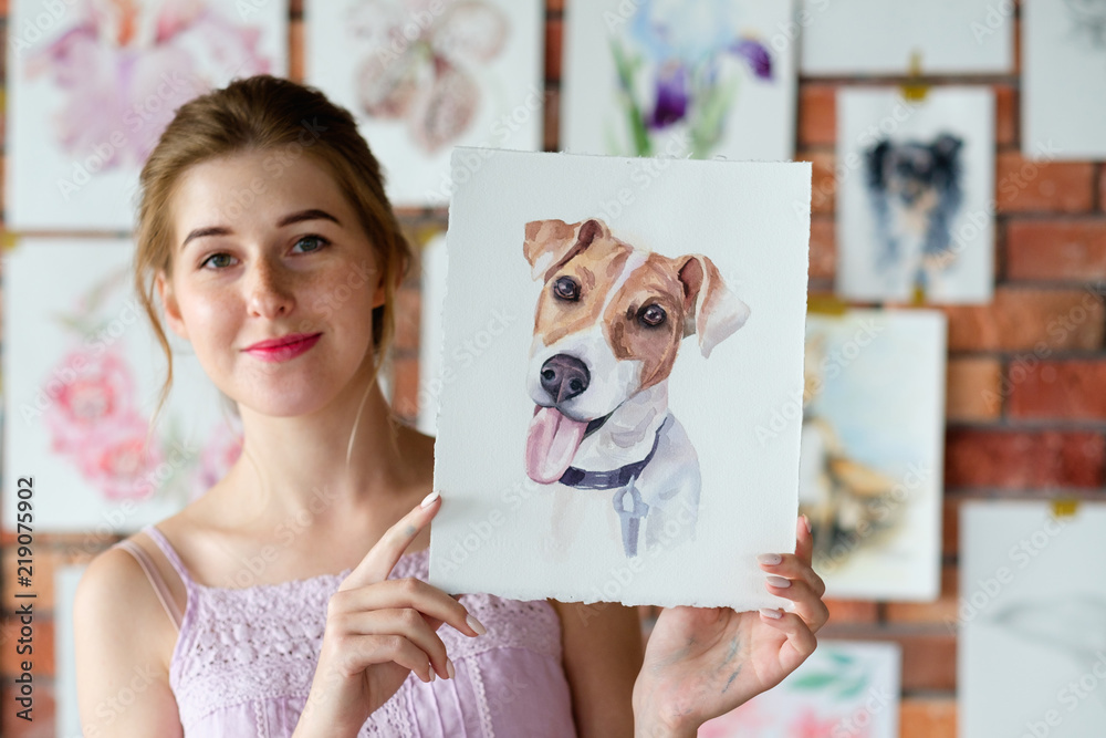 Naklejka premium creative art lifestyle. drawing hobby and self expression. painter holding a watercolor drawing of french bulldog dog