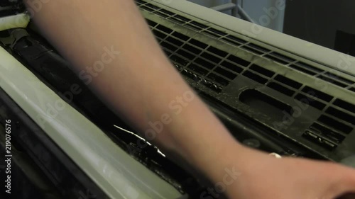 A large printing machine throws paper into a container.