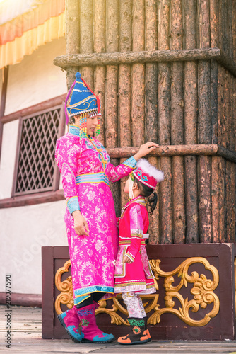 Mongolian mother and daughter staring at each other