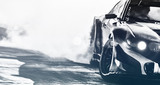 Blurred sport car drifting on speed track. Sport car wheel drifting and smoking with flare effect on track. Sport concept,drifting car concept.