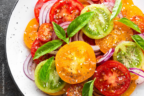 Tomato salad. Fresh vegetable salad with tomatoes, onion and basil