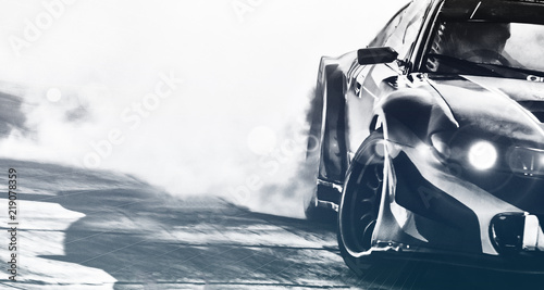Naklejka Niewyraźne samochód sportowy dryfujący na torze prędkości. Koło sportowe dryfuje i pali z efektem flary na torze. Pojęcie sportu, koncepcja dryfującego samochodu.