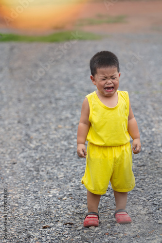 boy in yellow dress is crying