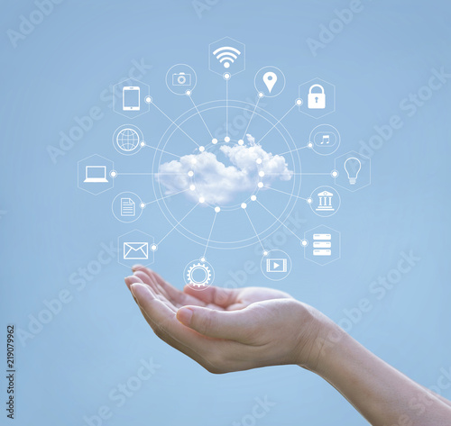 Cloud computing concept. Hands holding of cloud computing and icon network connection on blue sky. Technology of storage futuristic.