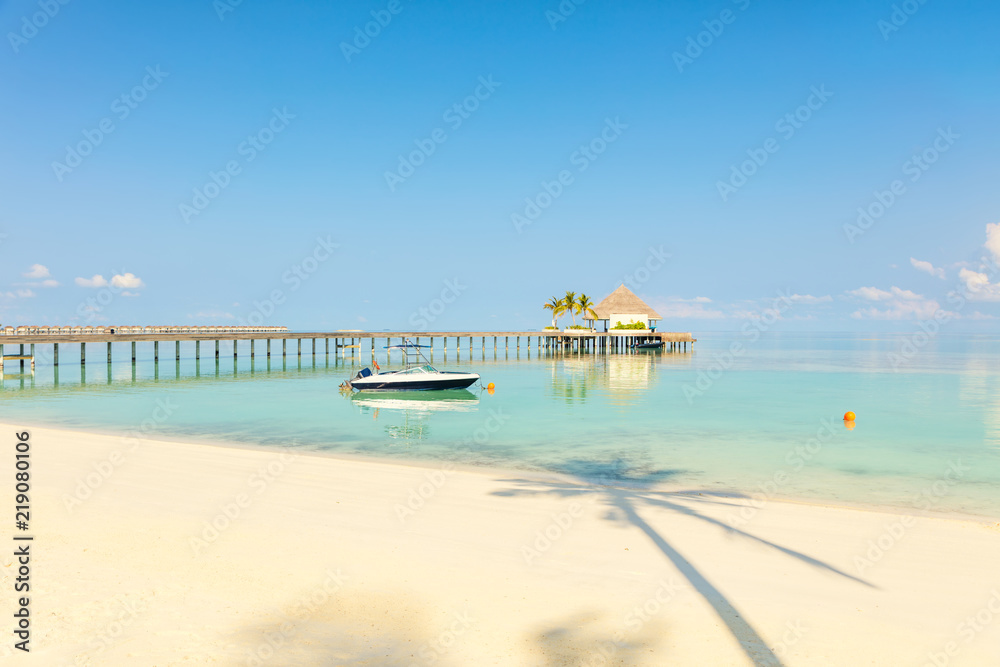 Wooden pier at tropical island resort, Maldives. Vacations And Tourism Concept