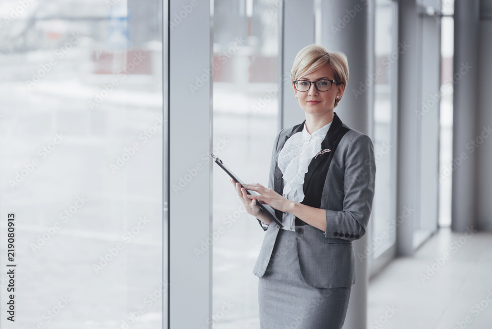 Fototapeta premium Smiling confident business woman looking at camera at office