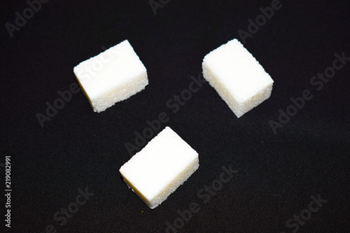 Sugar cubes, on a black background, isolated.