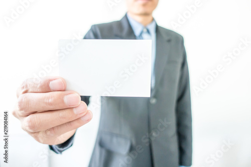 Business man showing his name card at meeting office. Selective focus