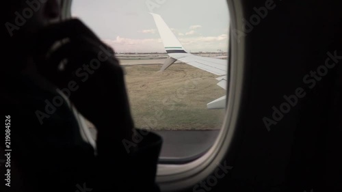 Wallpaper Mural Young woman looking out of plane window at take off Torontodigital.ca