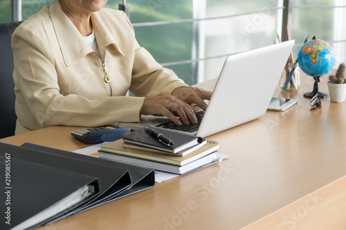 Business woman working with laptop at business office. Selective focus.