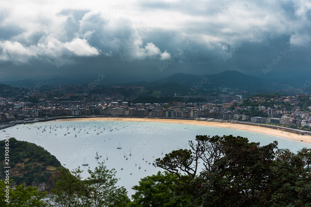 Fototapeta premium Dark clouds over San Sebastian city, Basque contry, Spain.