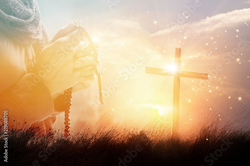 Double exposure. Woman with cross praying on nature sunset background, hope concept