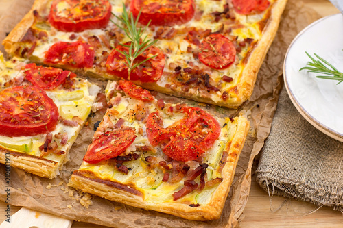 Puff pastry tart pizza style with tomatoes  courgette  and bacon