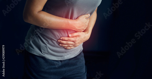 Obraz na plátne Woman touching stomach painful suffering from stomachache causes of menstruation period, gastric ulcer, appendicitis or gastrointestinal system desease