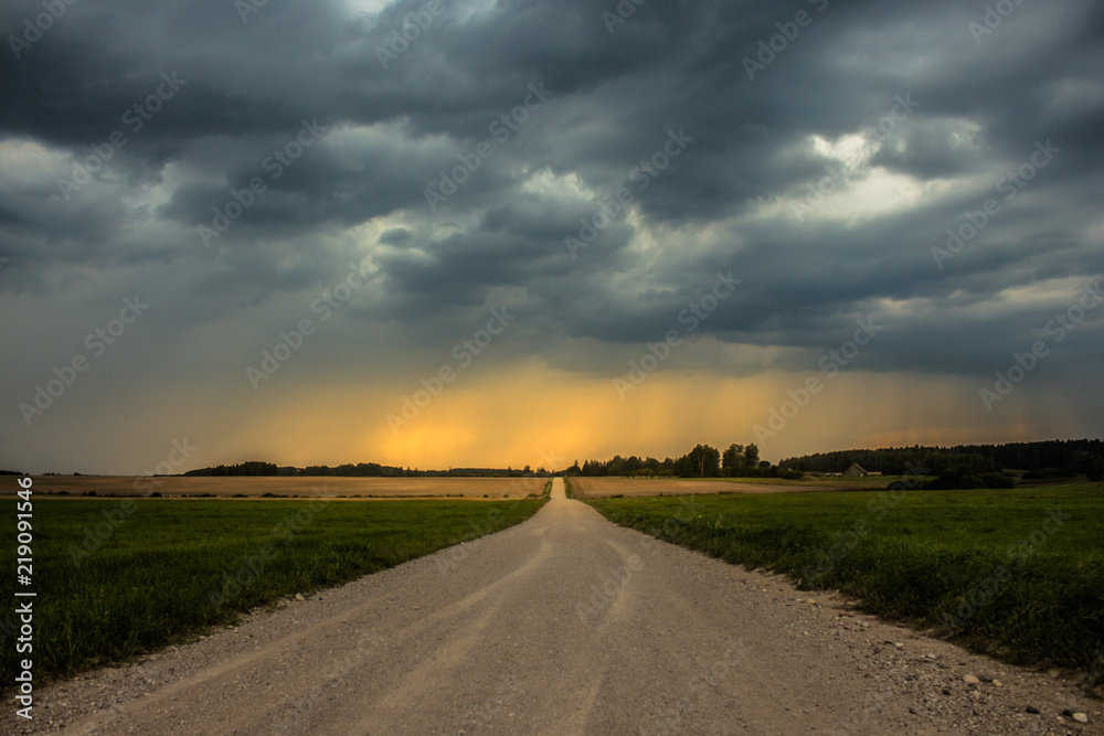 Long road which leads to the storm clouds