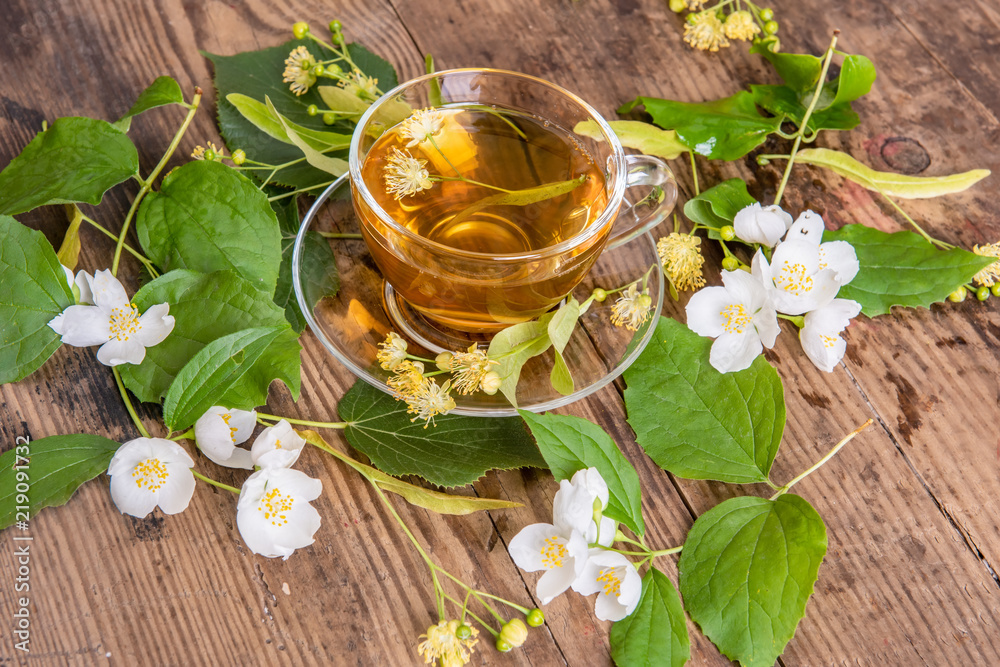 Cup of tea linden jasmine on wooden background Cup of tea linden jasmine on wooden background