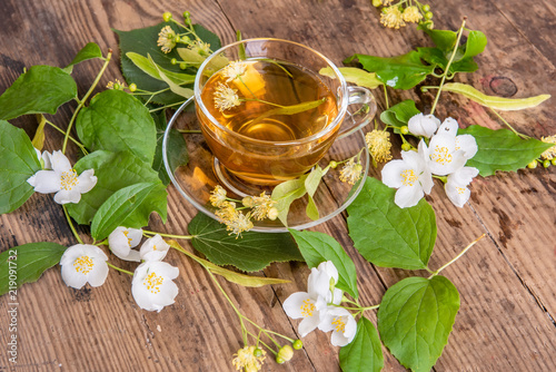 Cup of tea linden jasmine on wooden background