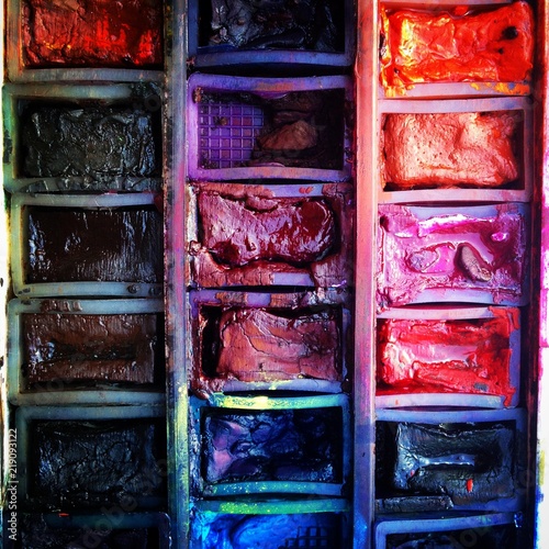 Well used artists watercolour paint palette close-up. Mobile phone photo with some phone or tablet post processing.