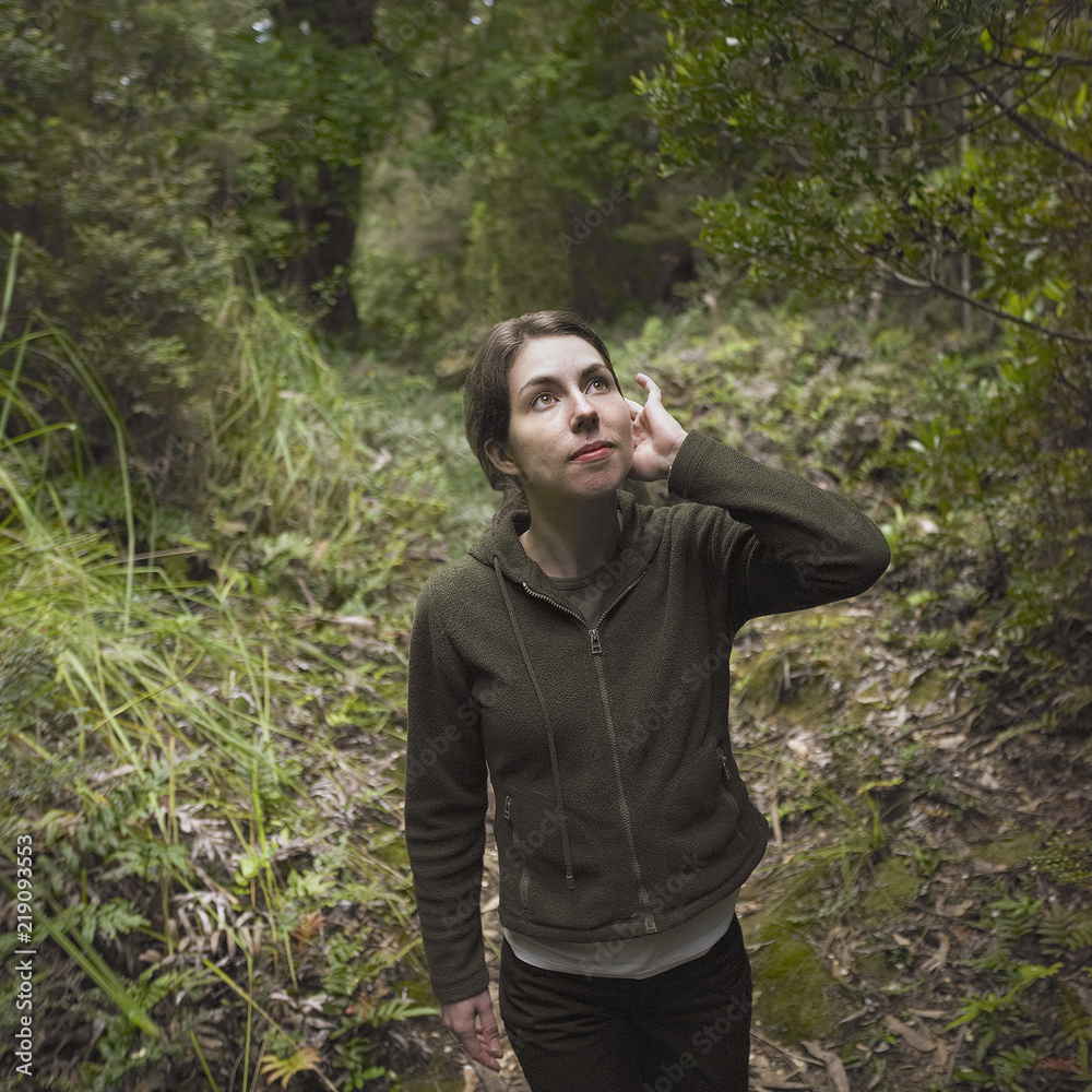 Young woman walking along a forest track Young woman walking along a forest track