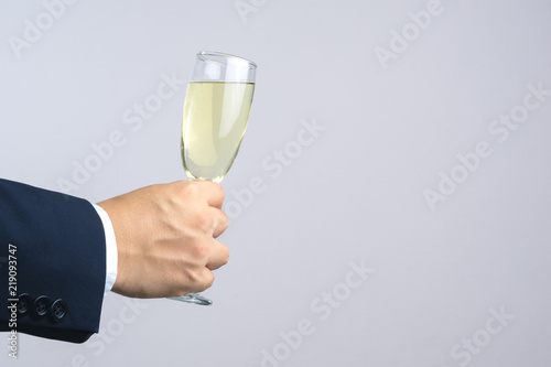 Business man hand holding glass of champagne for celebration