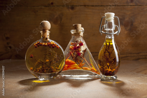 Bottles extra virgin olive oil with spices on a ceramic background