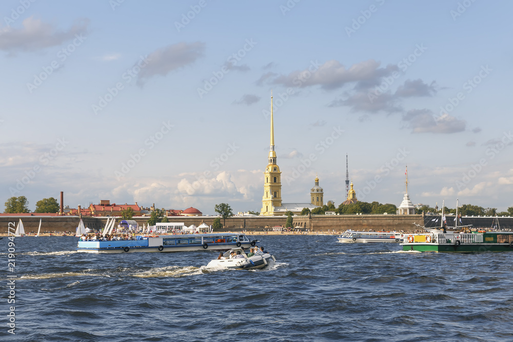 tourist ships on the Neva River against the background of an ancient fortress