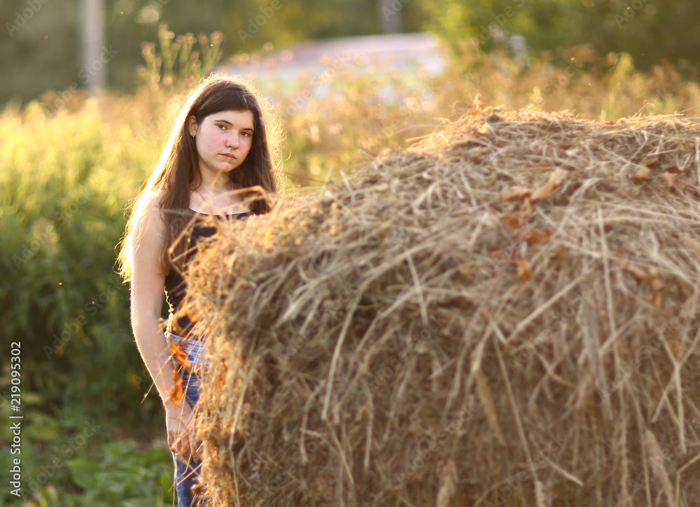 teenager farmer girl with haystack close up photo teenager farmer girl with haystack close up photo