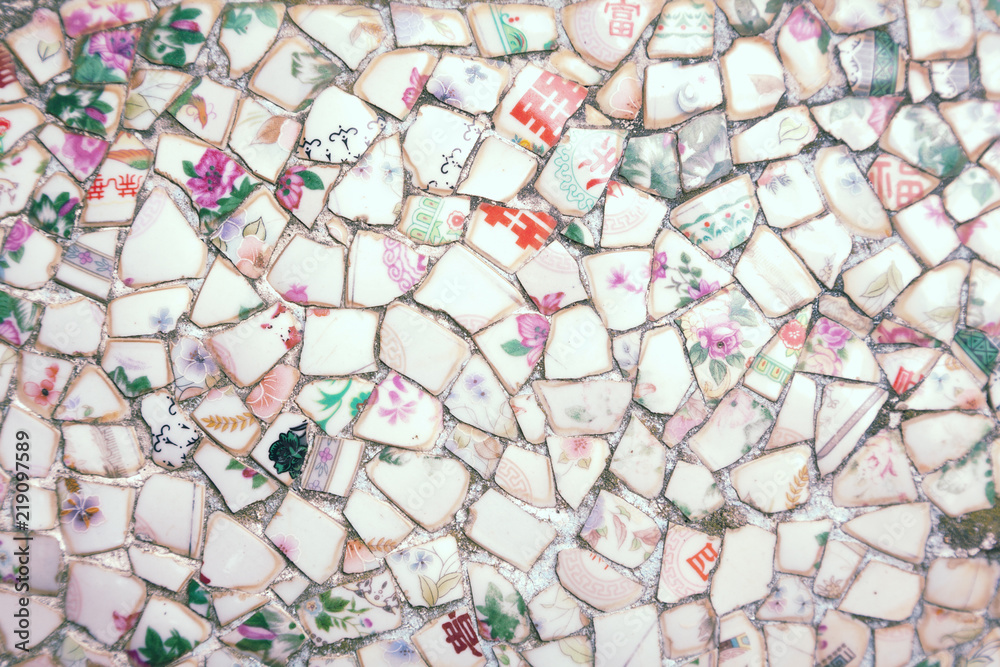 Mosaic made of broken crockery and tableware background. Wall tiled