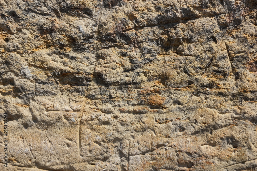 Texture of an old wall. Surface of an ancient temple in Prague. Background of stone for the designer. Vintage pattern in brown tones
