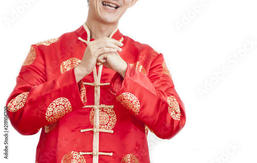 Asian man with Chinese traditional dress cheongsam or tang suit greeting. Chinese new year concept, male model  on white background. photo