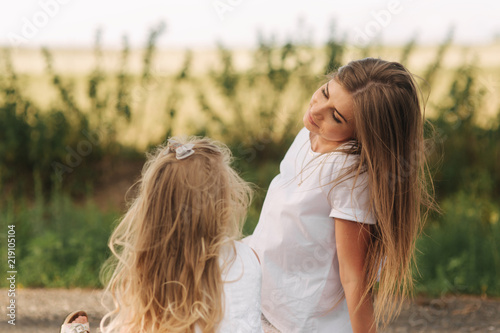 Beauty Mum and her Child playing in Park together. Outdoor Portrait of happy family. © Aleksandr