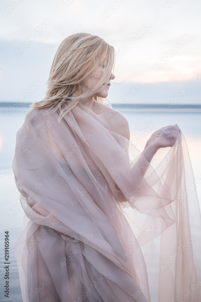 Fantastic girl in a light fabric on a lake in the water.
Fantastic girl in a light fabric on a lake in the water.