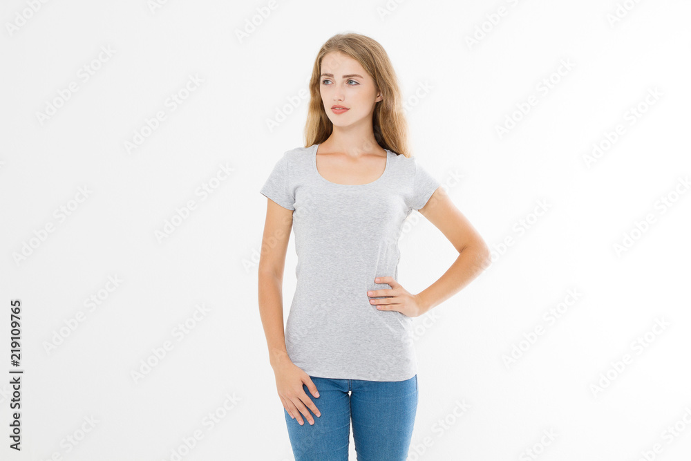 Young blonde woman with fit slim body in blank template t shirt and jeans isolated on white background. Skin and hair care. Copy space and mock up