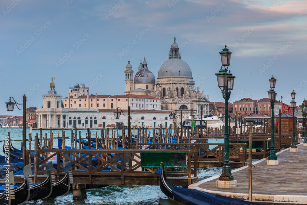 Gondola parking with Santa Maria della Salute at background in Venice, Italy
