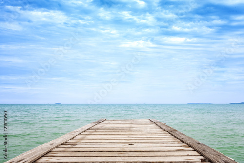 Old wooden bridge in the blue sea and beautiful sky
