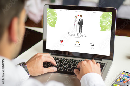 businessman browsing wedding website with computer photo