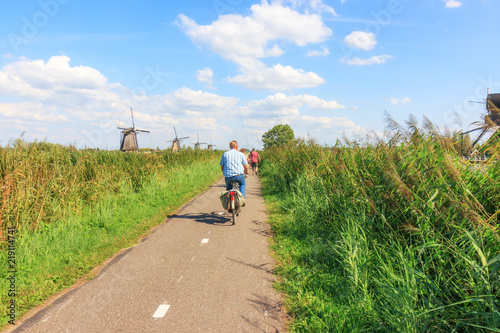 Kinderdijk, Netherlands - August 17, 2018: Tourists Cycling At Kinderdijk