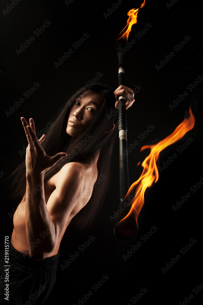 asian man with fire show