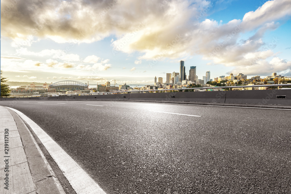 empty asphalt highway street with city skyline empty asphalt highway street with city skyline