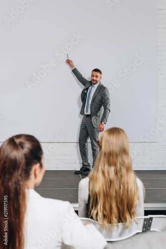 business coach pointing on board during training in hub