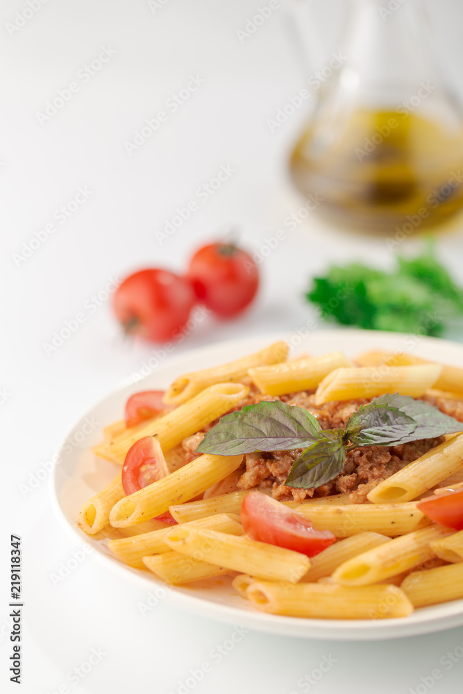 Pasta Fettuccine Bolognese with tomato sauce and basil in white dish on the white background. Pasta Fettuccine Bolognese with tomato sauce and basil in white dish on the white background.